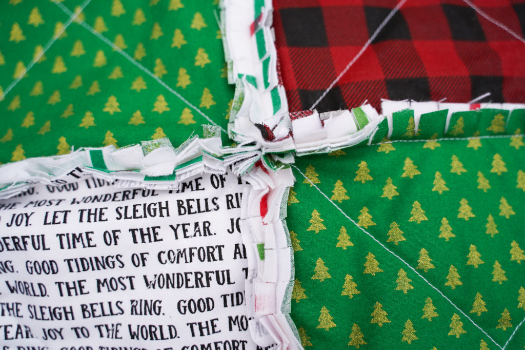 Clipping the seams on a Christmas rag quilt