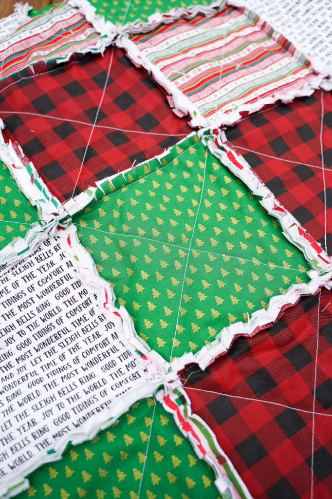Clipping the seams on a Christmas rag quilt