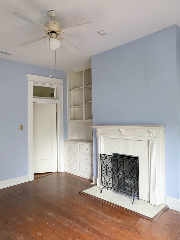 The before photo of our 100 year old office with original fireplace